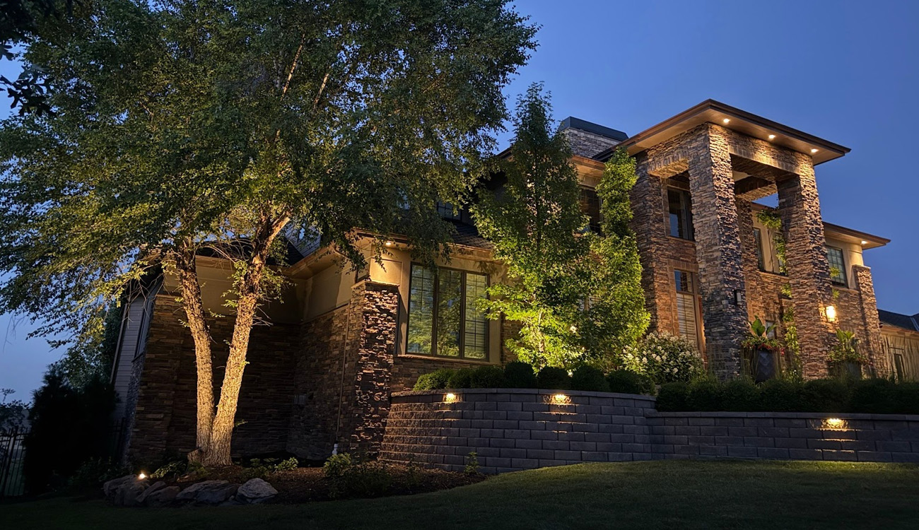 Elegant home illuminated by outdoor lighting.