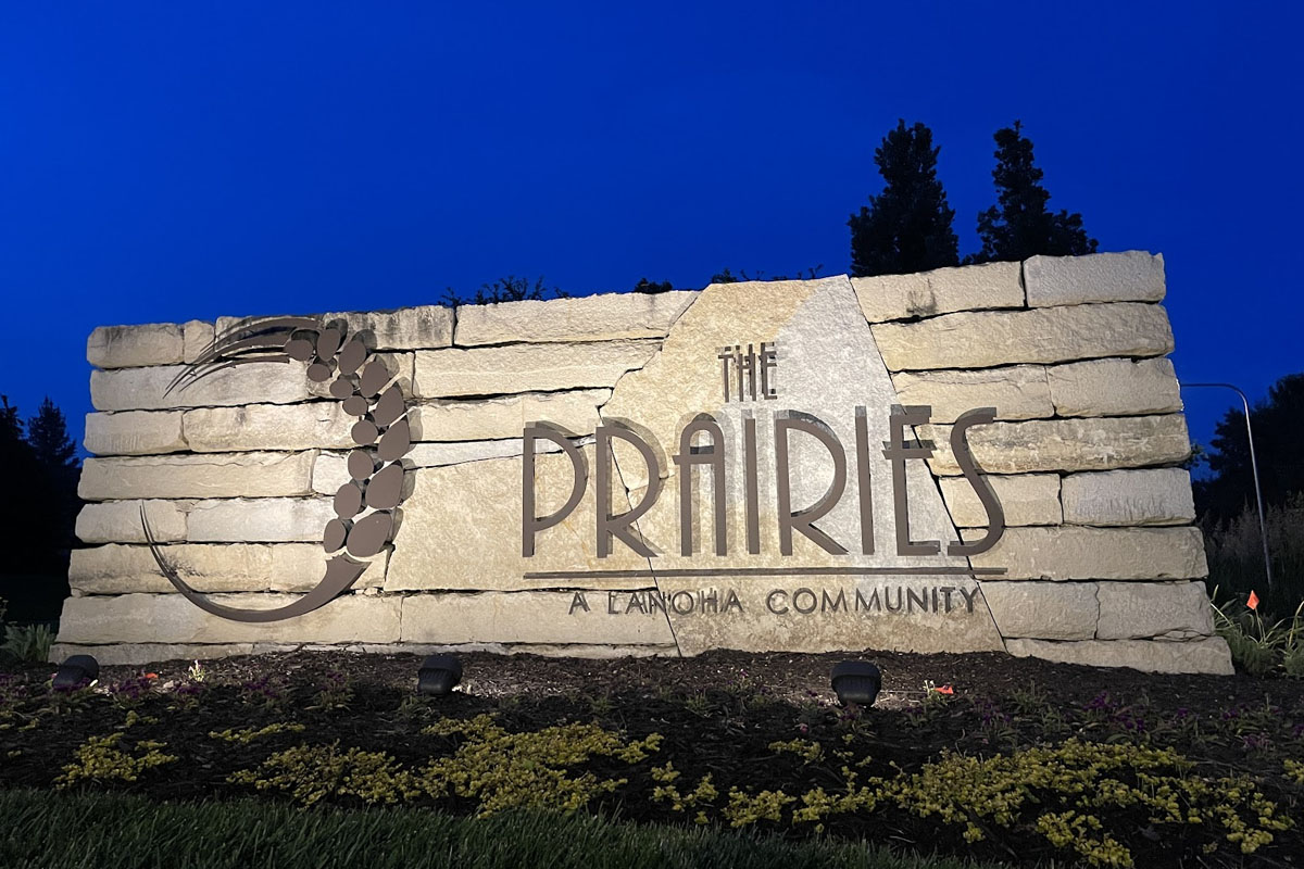 Entrance monument sign illuminated with commercial outdoor lighting solutions for clear visibility and nighttime branding.