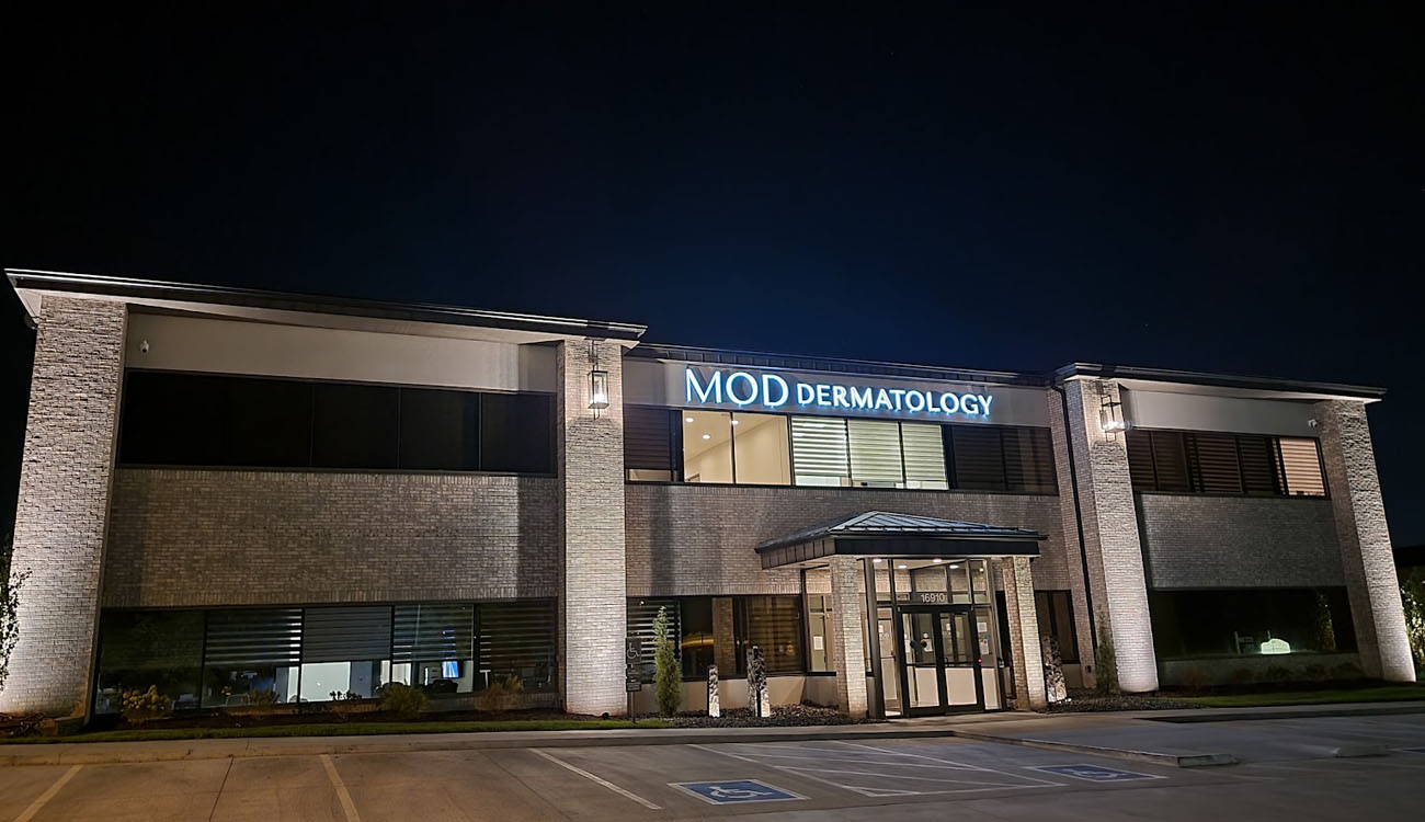 Modern two-story commercial building with professional parking lot lighting installed by expert contractors.