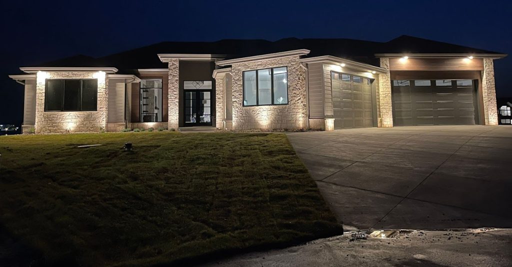Sleek, built-in lighting accents the clean lines and stone textures of a contemporary luxury home.