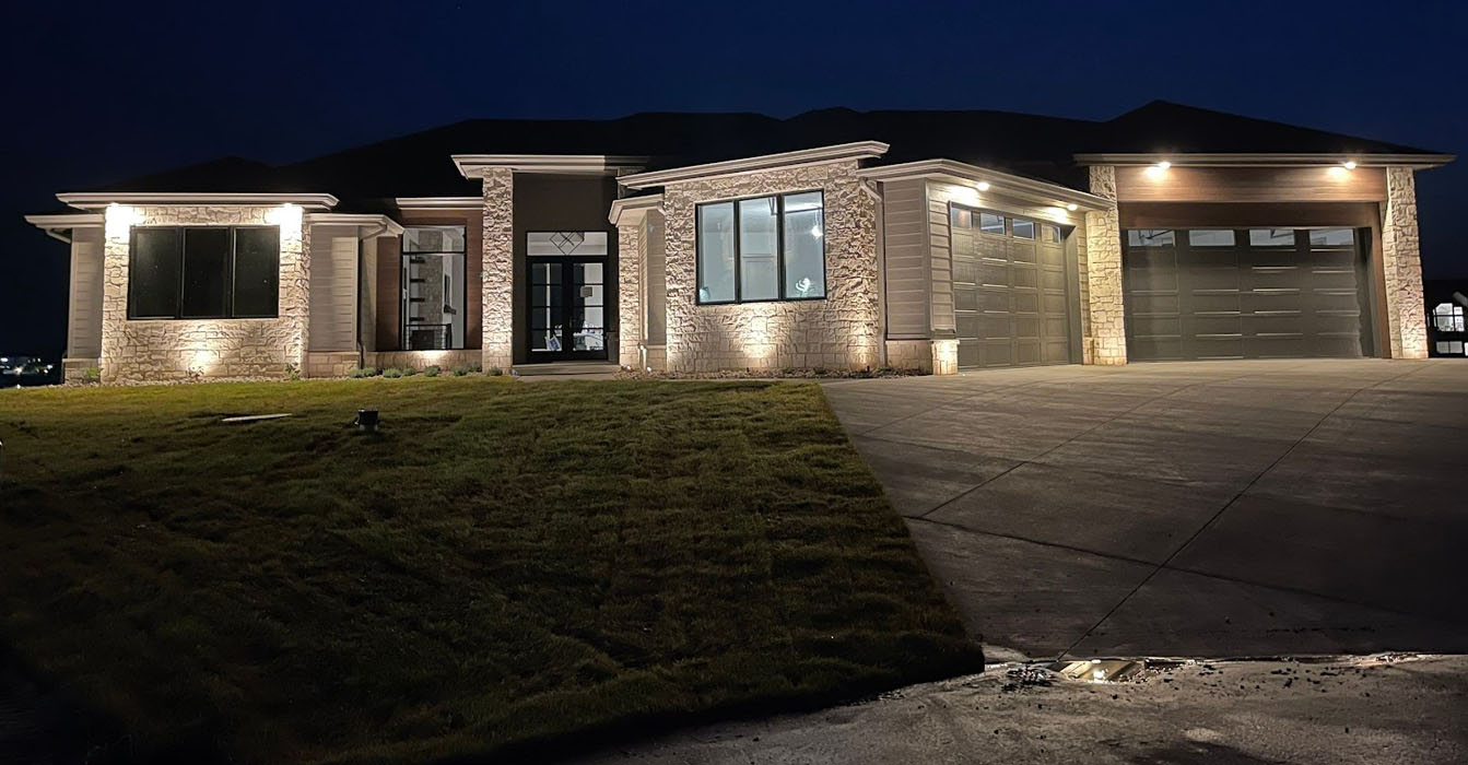 Sleek, built-in lighting accents the clean lines and stone textures of a contemporary luxury home.