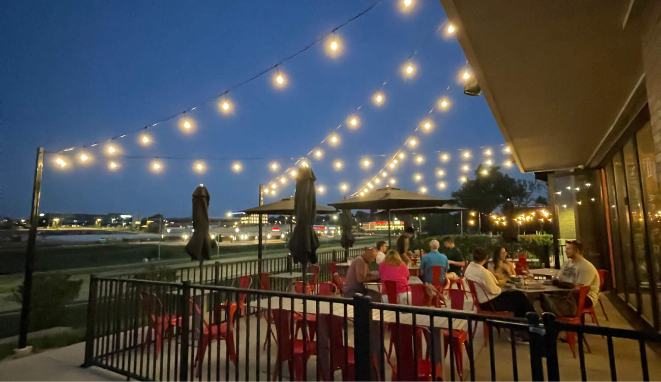 Outdoor string lights hanging between pergola posts