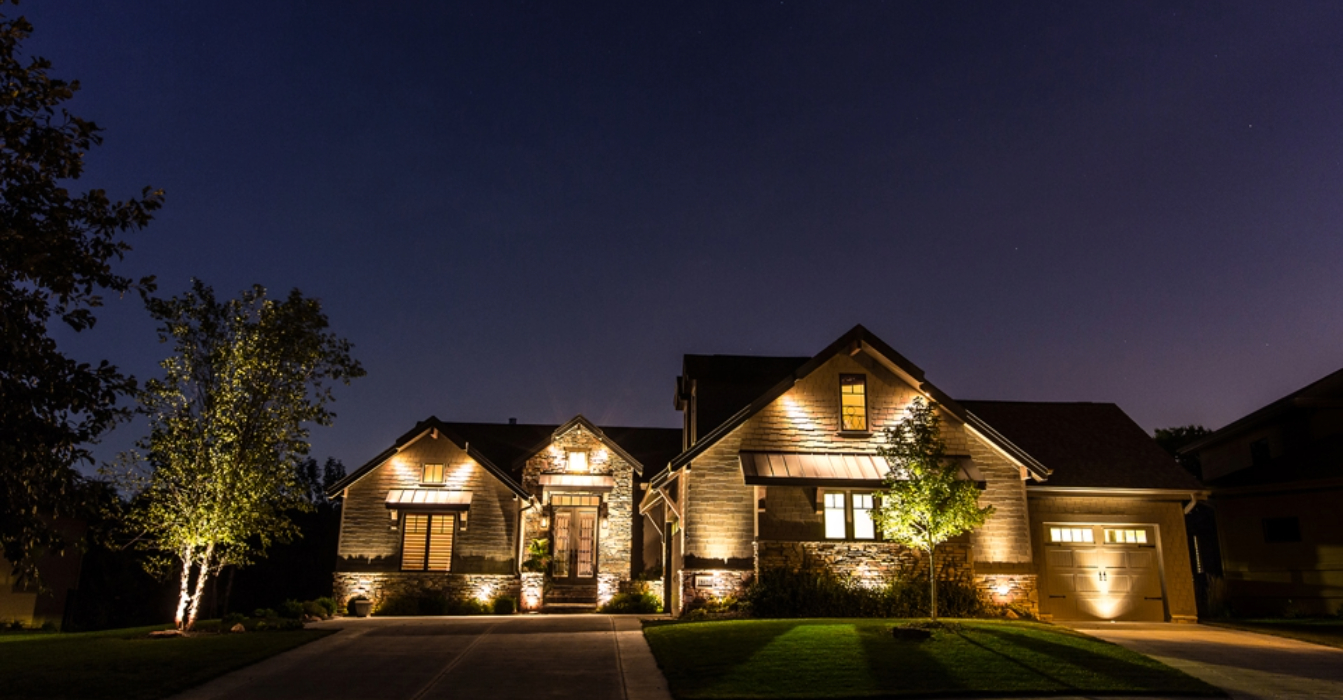 Front view of a home showing the results of a professional landscape lighting installation.