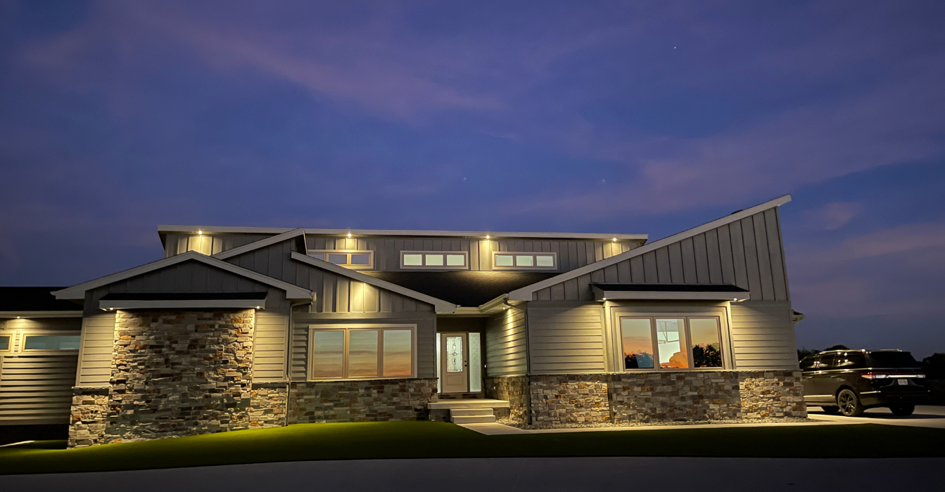 Modern Midwest home exterior with professionally maintained soffit lighting. Trust our experts for reliable landscape lighting repair to keep your property shining bright.