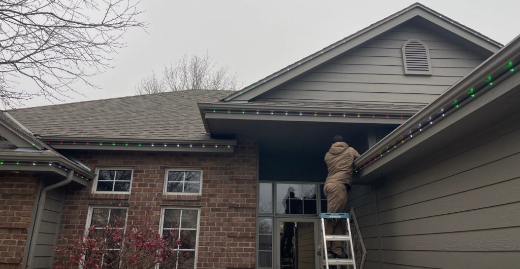 outdoor lighting maintenance omaha technician inspecting LED landscape fixtures spring