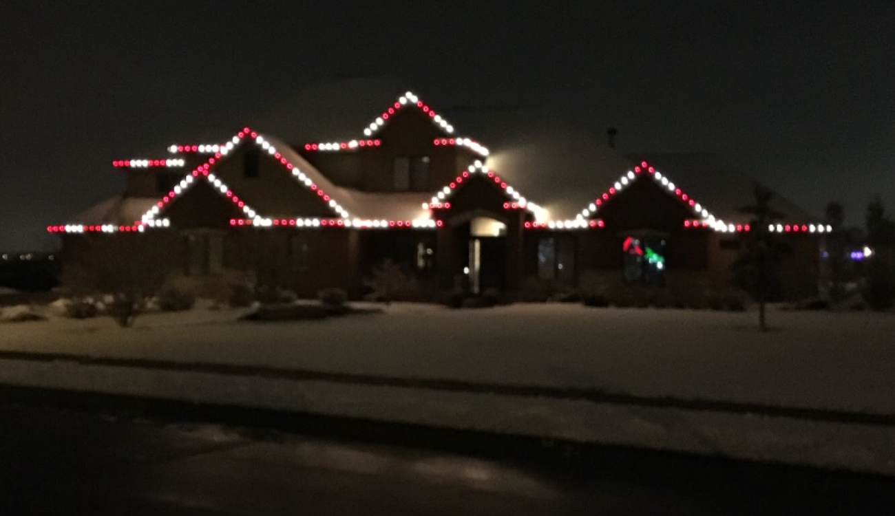 permanent roofline lighting omaha warm white accent eaves suburban Nebraska home dusk